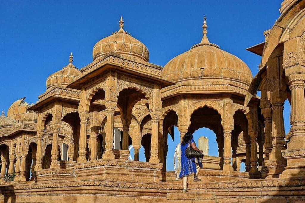 a woman walking up a stone building