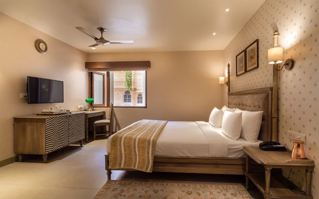 a bedroom with a bed and a desk