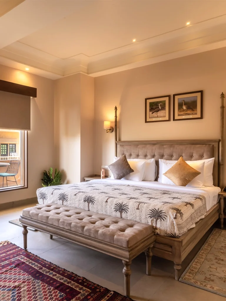 a bedroom with a bed and a bench