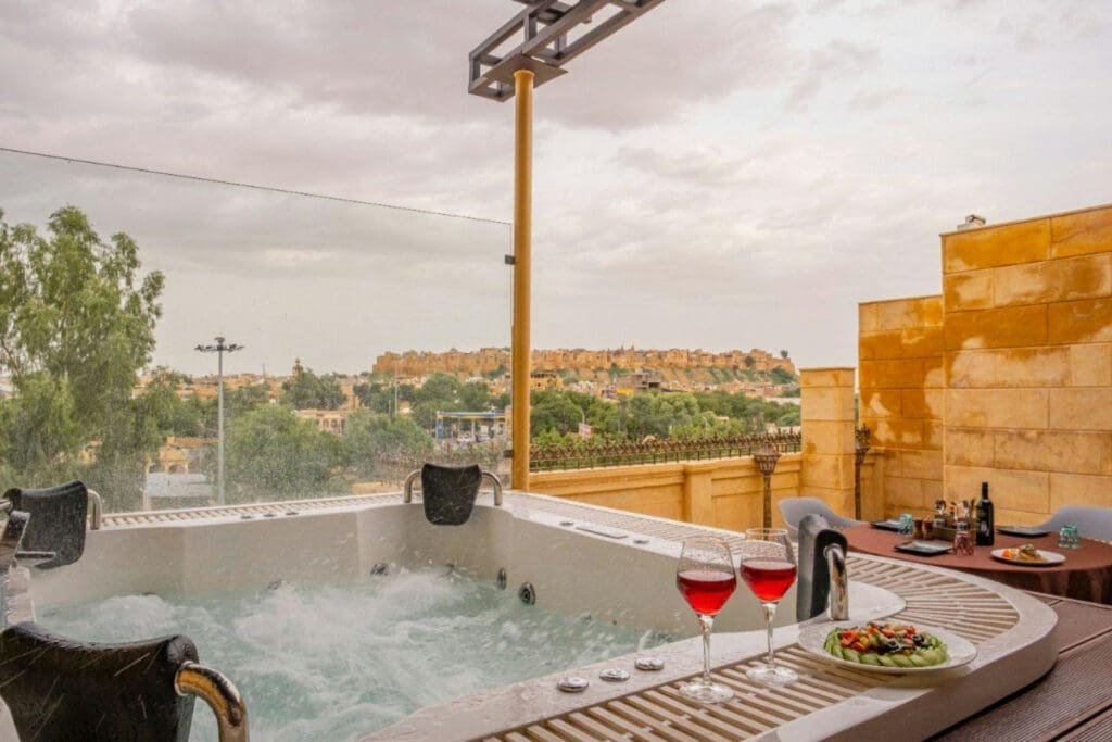 a hot tub with wine glasses on a table